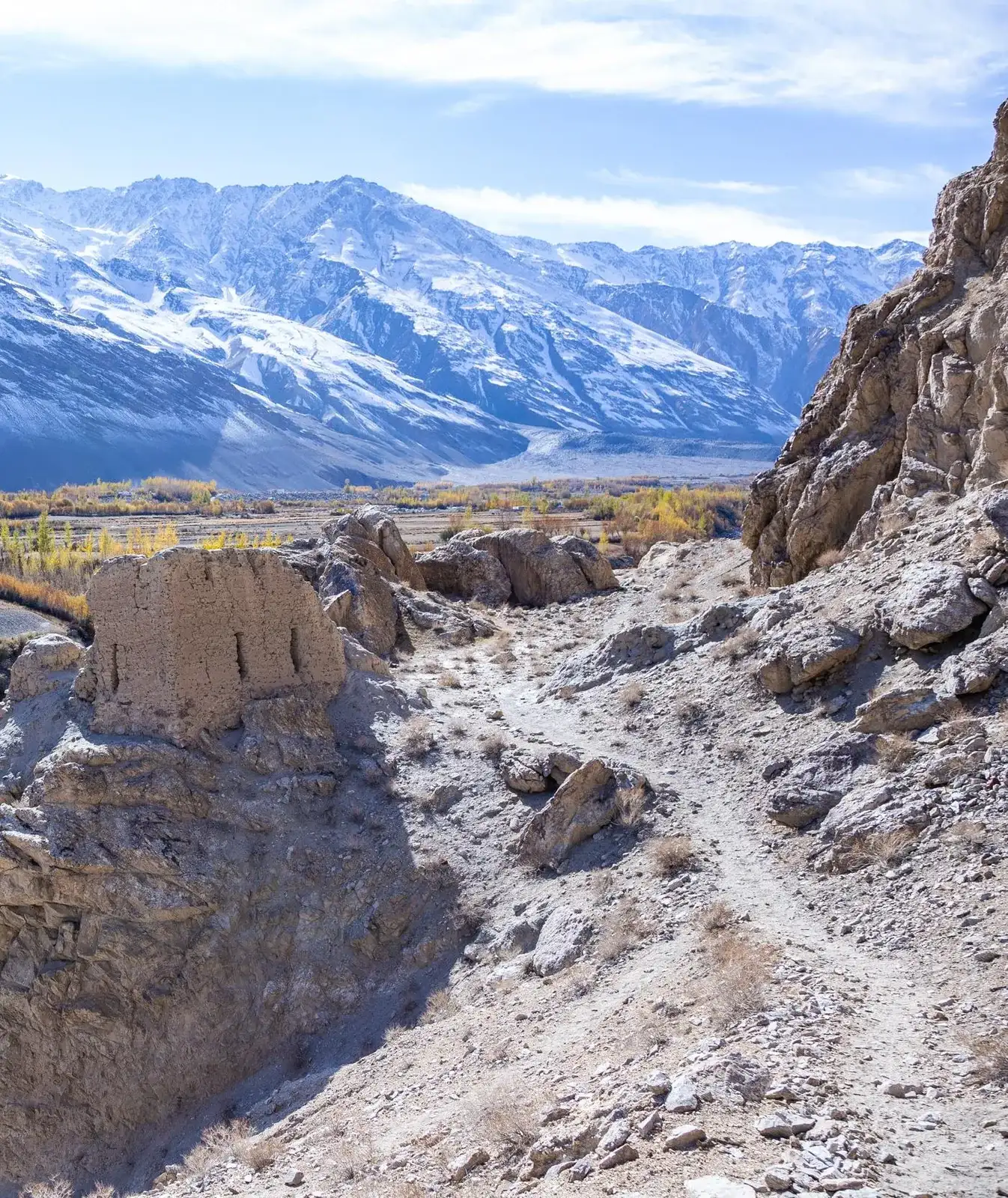 Ruins of a stone watchtower fortress on a sandy hill above the Pamir valley